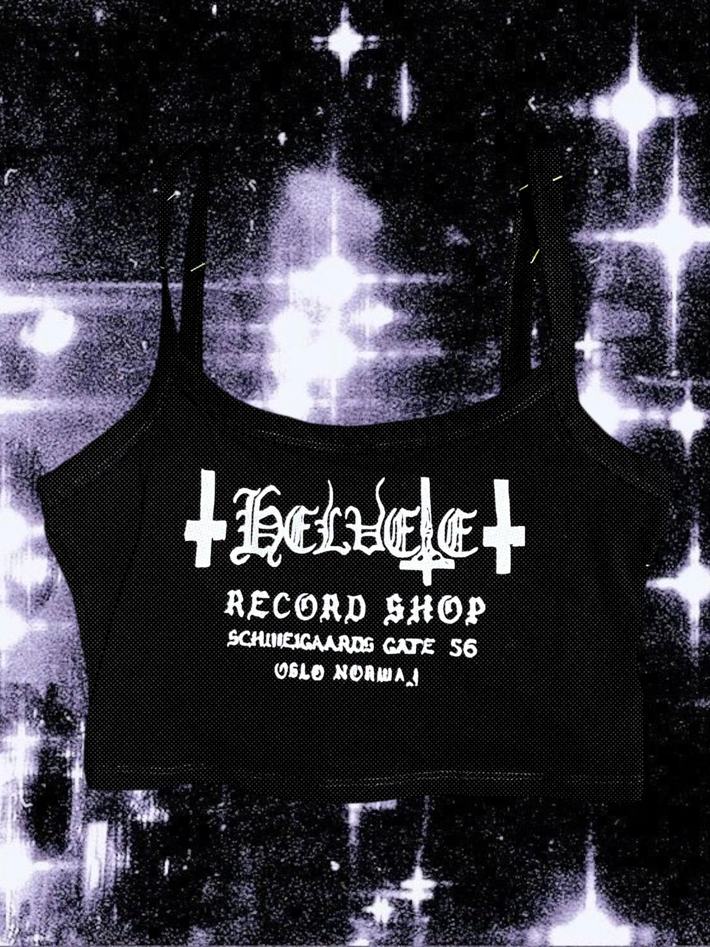 Black cropped spaghetti strap cami with “Helvete Record Shop” printed in white glitter vinyl. The design includes gothic text, upside-down crosses, and the address "Schweigaards Gate 56, Oslo Norway." Shirt is laid flat on a cosmic black-and-white starry background.