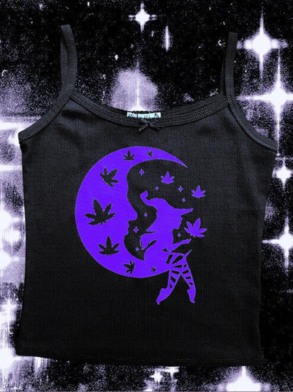 Black spaghetti strap tank top with a purple print of a seated witch on a crescent moon, surrounded by floating cannabis leaves and stars. The background is a cosmic, sparkly black-and-white space scene.