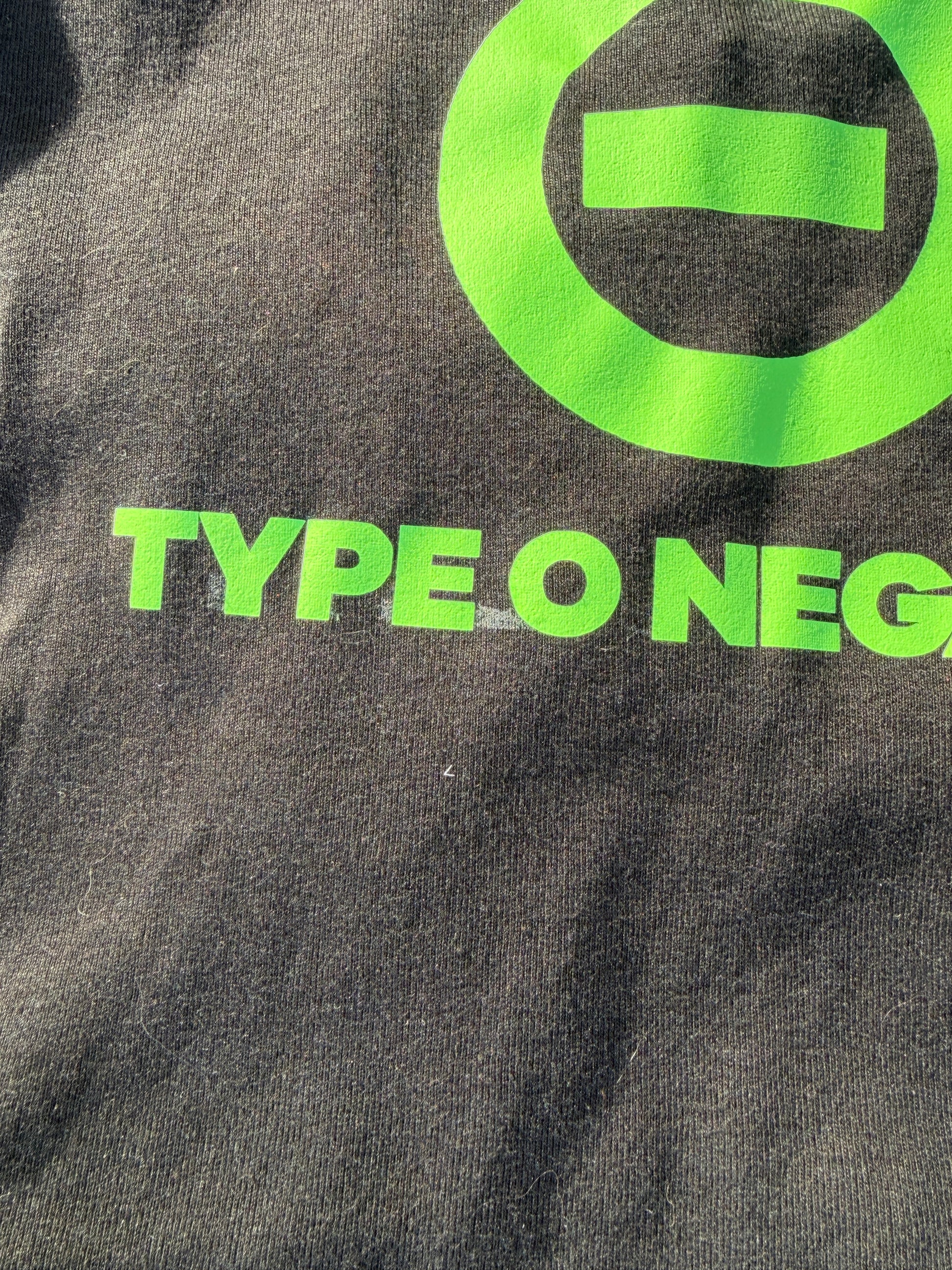 a close-up view of a dark-colored fabric with a large green logo and text printed on it.