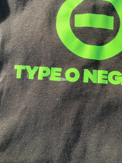a close-up view of a dark-colored fabric with a large green logo and text printed on it.