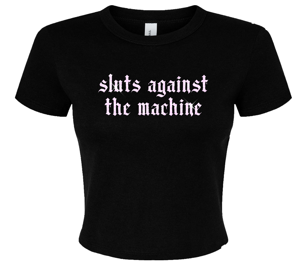 A black t-shirt with the text "sluts against the machine" printed on it in a stylized font.
