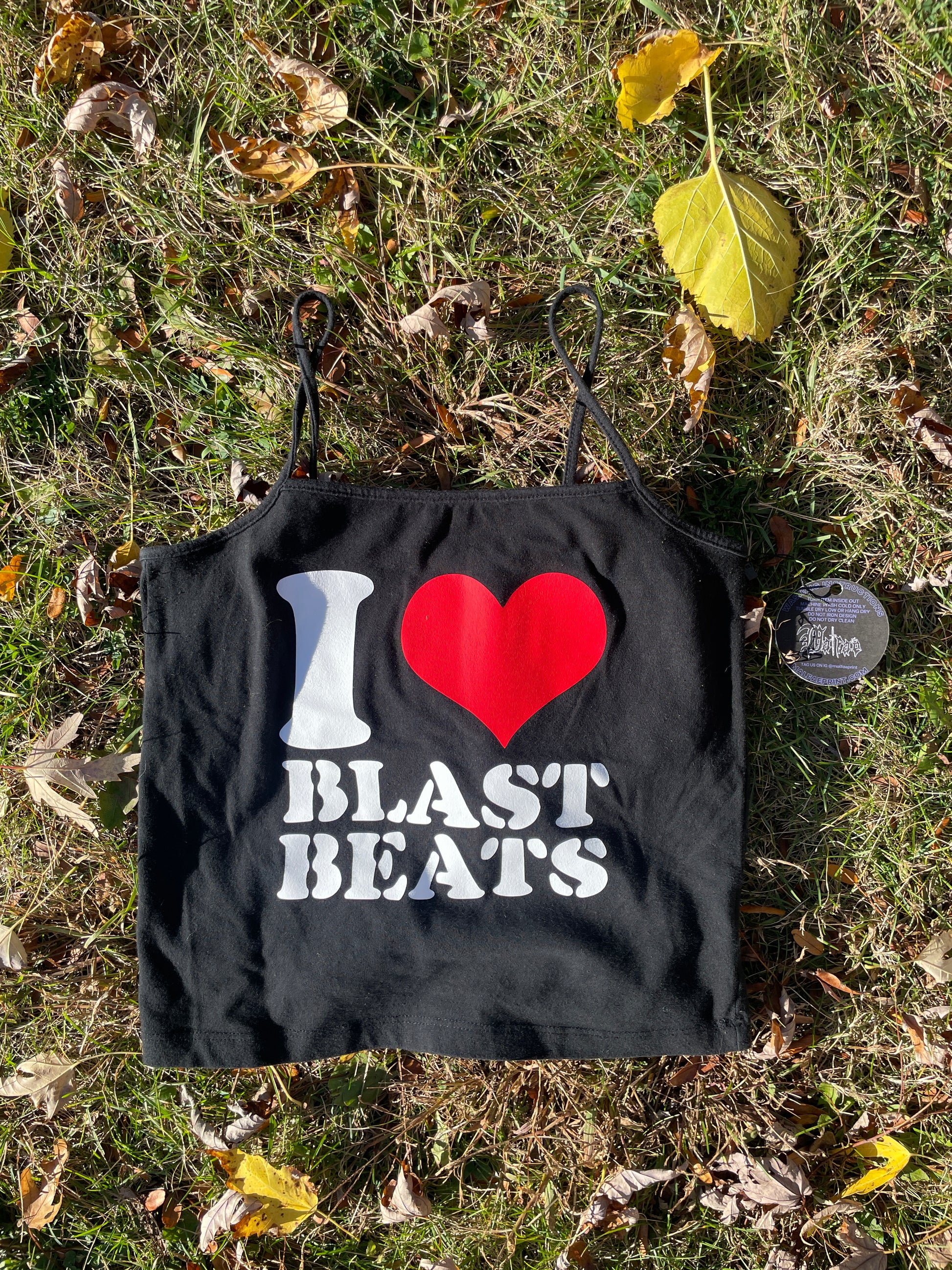 a black bag with a red heart on it laying in the grass